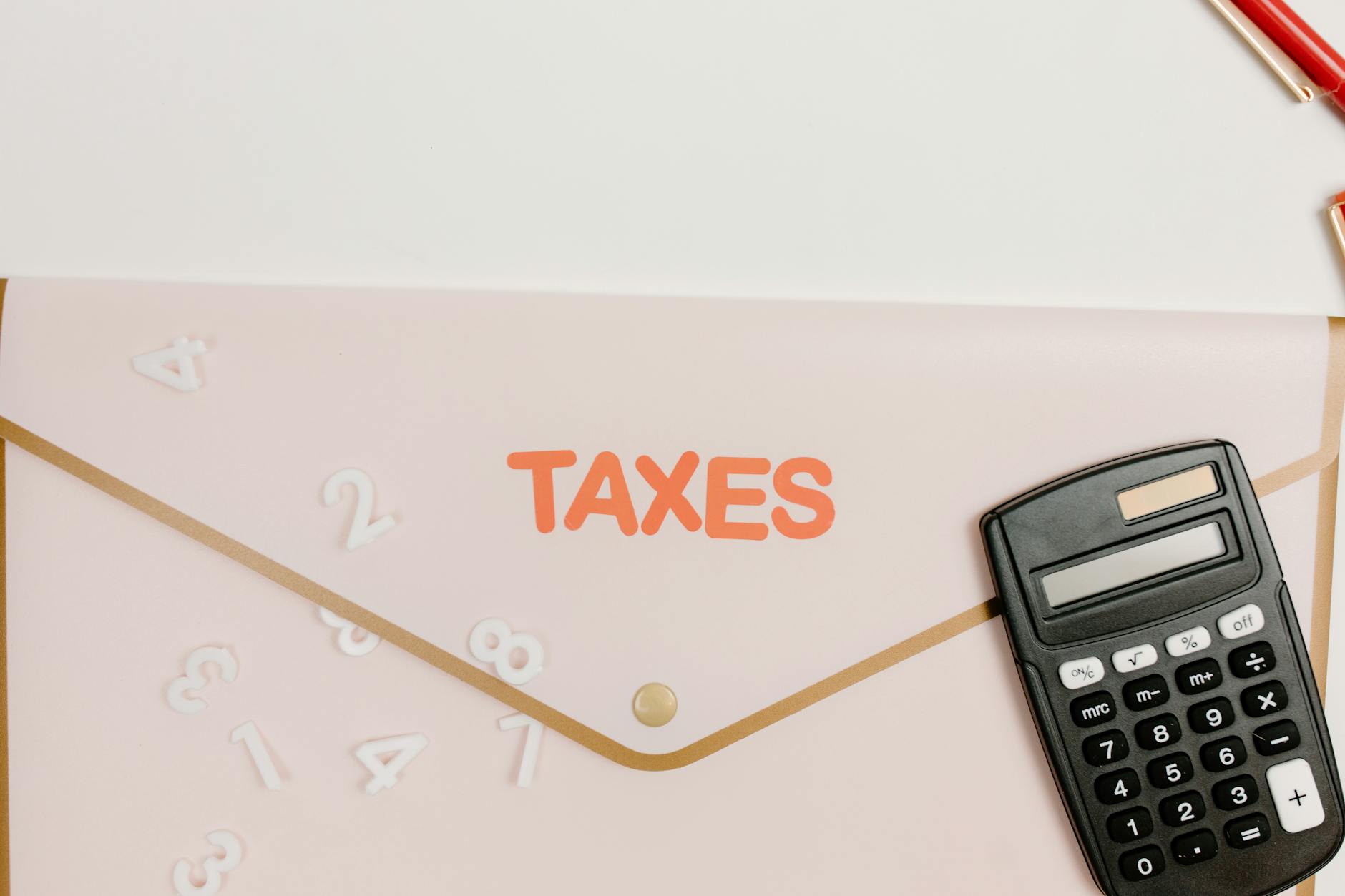 folder and calculator on white table